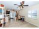 Bright home office featuring tile flooring, ceiling fans, and plenty of natural light at 8170 Casa De Meadows Dr, Englewood, FL 34224
