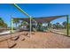 Bright and colorful community playground with slides and swings amidst swaying palms at 8170 Casa De Meadows Dr, Englewood, FL 34224