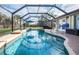 Enclosed pool and deck, enhanced with a screened enclosure and lush landscaping for privacy at 8170 Casa De Meadows Dr, Englewood, FL 34224