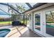 Screened-in porch with access to a pool, spa, backyard, and outdoor shower, perfect for relaxation at 8170 Casa De Meadows Dr, Englewood, FL 34224