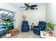 Cozy sunroom featuring two recliners, ceiling fan and view of the pool at 8170 Casa De Meadows Dr, Englewood, FL 34224