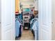 Walk-in closet with clothing racks, overhead storage, and tiled flooring at 8170 Casa De Meadows Dr, Englewood, FL 34224