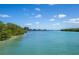 Serene waterfront view of the channel featuring lush greenery and tranquil blue waters and picturesque scenery at 8170 Casa De Meadows Dr, Englewood, FL 34224