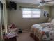 Bedroom with a mirrored closet door, ceiling fan, and TV at 822 Bogie St, Venice, FL 34285