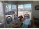 Bright dining room featuring a glass-top table with decorative table runner, surrounded by wicker-backed chairs at 822 Bogie St, Venice, FL 34285