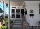 Inviting entrance with decorative plants, a welcome sign, and charming details create a warm first impression at 822 Bogie St, Venice, FL 34285