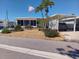 Charming single-story home featuring a carport, well-manicured landscaping, and a welcoming front facade at 822 Bogie St, Venice, FL 34285
