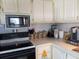 Efficient kitchen showcasing white cabinetry, modern appliances, and ample counter space at 822 Bogie St, Venice, FL 34285