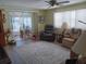 Open living room featuring wood-look floors, a ceiling fan, and comfortable furnishings at 822 Bogie St, Venice, FL 34285
