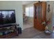 View into dining room with table, chairs, and view, with living room and TV visible at 822 Bogie St, Venice, FL 34285
