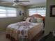 Comfortable main bedroom with a large bed, ceiling fan, and serene decor at 822 Bogie St, Venice, FL 34285