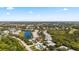 Expansive aerial view showcases the community's homes, lakes, golf course, and verdant green space under a blue sky at 902 Tartan Dr # 29, Venice, FL 34293