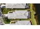 Community aerial view with tile roofs, lush landscaping, and water views at 902 Tartan Dr # 29, Venice, FL 34293