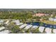 Aerial view of the community with mature trees, water views, and nearby shopping destinations at 902 Tartan Dr # 29, Venice, FL 34293