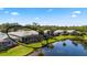 A view from the air of the house with the covered patio next to the pond at 902 Tartan Dr # 29, Venice, FL 34293