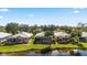 Aerial view showcases tiled roofs, screened lanais, and serene waterfront setting at 902 Tartan Dr # 29, Venice, FL 34293