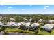 Aerial view of community highlighting lush landscaping and beautiful pond at 902 Tartan Dr # 29, Venice, FL 34293