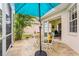 Backyard patio featuring a table with chairs, landscaping, and a lake view at 902 Tartan Dr # 29, Venice, FL 34293