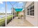 Long backyard patio with a blue umbrella and view of a lake and landscaping at 902 Tartan Dr # 29, Venice, FL 34293