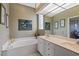 Bathroom featuring a soaking tub and expansive mirror offers a relaxing spa-like experience at 902 Tartan Dr # 29, Venice, FL 34293