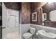 Nicely appointed bathroom showcasing wallpaper, decorative art, and a modern toilet and sink at 902 Tartan Dr # 29, Venice, FL 34293