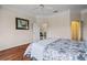 Bedroom with hardwood floors offers a calm atmosphere and a view to another room at 902 Tartan Dr # 29, Venice, FL 34293