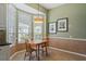 Bright breakfast nook with views boasts a stylish light fixture and seating for two at 902 Tartan Dr # 29, Venice, FL 34293