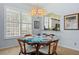 Dining room featuring shutters and a chandelier with a four person table at 902 Tartan Dr # 29, Venice, FL 34293