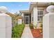 Pathway to the front entrance features decorative plants, mulch, and manicured hedges at 902 Tartan Dr # 29, Venice, FL 34293