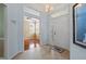 Light-filled foyer with tile flooring, blue accent walls, and views into the home's living spaces at 902 Tartan Dr # 29, Venice, FL 34293