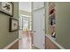 Hallway with a view of the kitchen, dining area, and built-in shelves at 902 Tartan Dr # 29, Venice, FL 34293