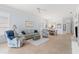 Bright living room with neutral tones, comfortable seating, and an open view into the dining area at 902 Tartan Dr # 29, Venice, FL 34293