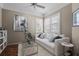 Well-lit living room with hardwood floors, a large window, and a comfortable white sofa at 902 Tartan Dr # 29, Venice, FL 34293
