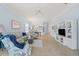Spacious living room featuring tile floors, ceiling fan, sofa, and chairs at 902 Tartan Dr # 29, Venice, FL 34293