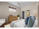 Bright main bedroom features a ceiling fan, wood dresser, and walk-in closet leading to the main bathroom at 902 Tartan Dr # 29, Venice, FL 34293
