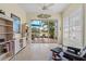 Bright sun room featuring tile floors, ceiling fan, and access to the backyard at 902 Tartan Dr # 29, Venice, FL 34293