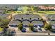 Aerial view of community condos with garages and manicured landscaping near the golf course at 903 Gondola Park Dr # 903, Venice, FL 34292