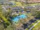 Aerial view of tennis courts and manicured landscaping in a neighborhood near a golf course at 903 Gondola Park Dr # 903, Venice, FL 34292