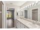 Bathroom featuring double sinks, large mirror with modern lighting, open view to living space at 903 Gondola Park Dr # 903, Venice, FL 34292