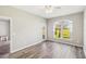A bedroom with gray walls and light wood flooring with a large arched window and a glass door at 903 Gondola Park Dr # 903, Venice, FL 34292