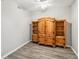Clean, well-lit bedroom featuring hardwood floors and a wooden armoire at 903 Gondola Park Dr # 903, Venice, FL 34292
