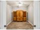 Empty bedroom with gray walls and wood-look floors, featuring built-in wooden cabinets at 903 Gondola Park Dr # 903, Venice, FL 34292
