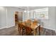 Open-concept dining room with wooden table, chairs, and view of the kitchen at 903 Gondola Park Dr # 903, Venice, FL 34292