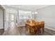 Cozy dining room with hardwood floors adjacent to a well-lit kitchen at 903 Gondola Park Dr # 903, Venice, FL 34292