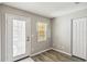 Bright entry room featuring wood-look floors, closet, and backyard access at 903 Gondola Park Dr # 903, Venice, FL 34292