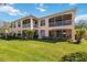Beautiful view of the rear exterior with screened lanais and lush lawn at 903 Gondola Park Dr # 903, Venice, FL 34292