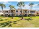 Beautiful condo community with lush green lawns, tall palms and well-maintained landscaping at 903 Gondola Park Dr # 903, Venice, FL 34292