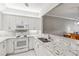Well-lit kitchen featuring granite countertops and white cabinets with modern appliances at 903 Gondola Park Dr # 903, Venice, FL 34292