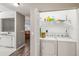 Convenient laundry room featuring a washer, dryer, and additional storage space at 903 Gondola Park Dr # 903, Venice, FL 34292