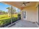 Inviting screened patio with golf course view, tiled flooring, and access to the backyard at 903 Gondola Park Dr # 903, Venice, FL 34292